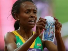 Meseret Defar of Ethiopia holds up a picture at the London 2012 Olympic Games on August 10, 2012 in London, England. 