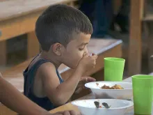 Migrant child has lunch at the Casa de Paso "Divina Providencia" in Cucuta.