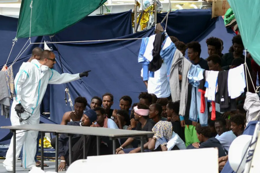 Migrants on the the Italian Coast Guard vessel Diciotti wait to embark. ?w=200&h=150