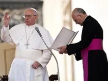 Msgr. Alfred Xuereb, newly appointed prelate secretary general of the Secretariat for the Economy, assists Pope Francis at a General Audience, April 17, 2013. 