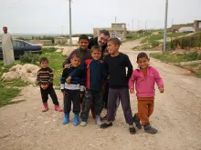 Msgr. Segundo Tejado Munoz, undersecretary of the Pontifical Council Cor Unum, with refugee children in Iraq, March 28, 2015. 