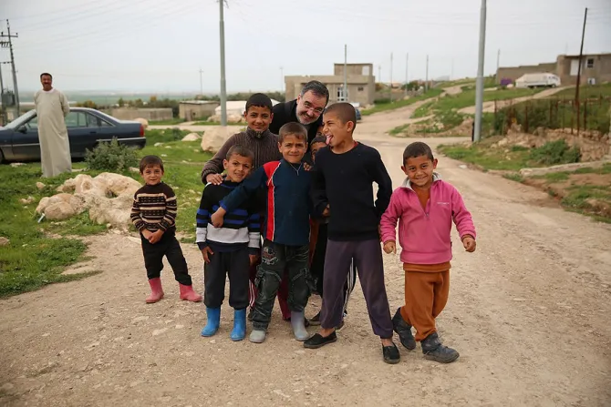 Mons Segundo Tejado Munoz under secretary of Pontificio Consiglio Cor Unum with refugee children Iraq on March 28 2015 Credit Daniel Ibanez CNA 3 31 15