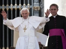 Archbishop Georg Ga?nswein stands behind Pope Benedict XVI in St. Peter's Square. 
