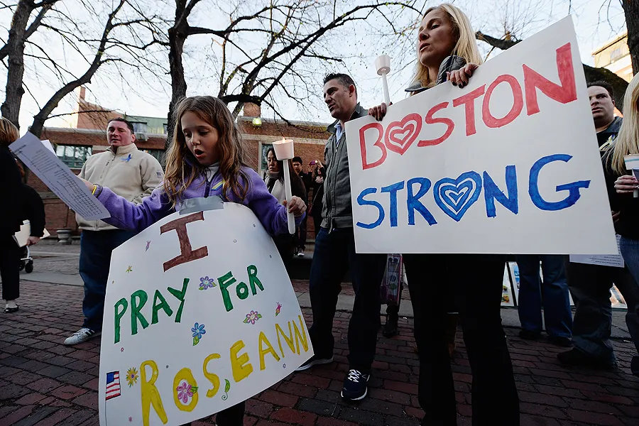 Mother and daughter at a candelight vigil for those injured and killed during the Boston Marathon bombings on April 21, 2013. ?w=200&h=150