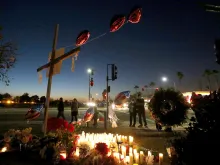 Mourners gather at a makeshift memorial near the Inland Regional Center, Dec. 4, 2015 in San Bernardino, California. 