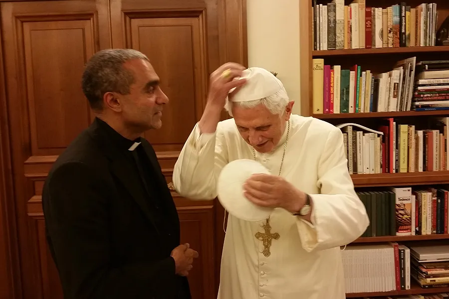 Msgr. Anthony Figueiredo exhanges a white, papal zucchetto with Benedict XVI at the Vatican on Nov. 7, 2014. Photo courtesy of Caritas in Veritate International.?w=200&h=150