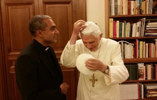 Msgr. Anthony Figueiredo exhanges a white, papal zucchetto with Benedict XVI at the Vatican on Nov. 7, 2014. Photo courtesy of Caritas in Veritate International.