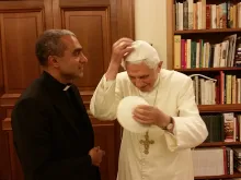 Msgr. Anthony Figueiredo exhanges a white, papal zucchetto with Benedict XVI at the Vatican on Nov. 7, 2014. Photo courtesy of Caritas in Veritate International.