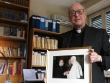 Msgr. Ignacio Barreiro, director of HLI's Rome office, holds a photo of himself with Pope Benedict during a Feb. 15, 2013 interview. 