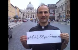 Msgr. Melchor Sanchez, undersecretary at the Pontifical Council for Culture, holds a sign with the hashtag in front of the Vatican. ?w=200&h=150