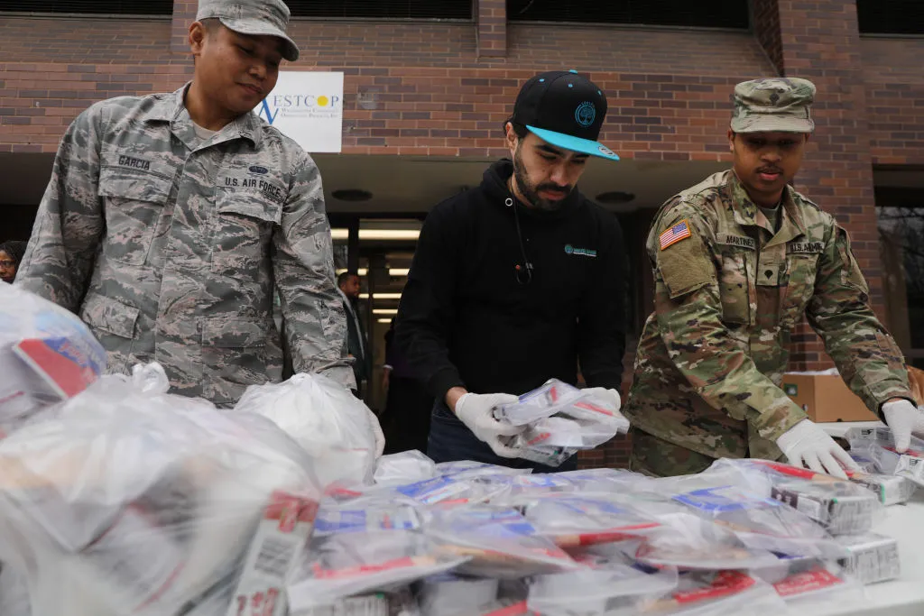 National Guard members hand out food to residents near a one-mile radius "containment area" set up to halt coronavirus March 12, 2020 in New Rochelle, New York. ?w=200&h=150