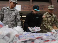 National Guard members hand out food to residents near a one-mile radius "containment area" set up to halt coronavirus March 12, 2020 in New Rochelle, New York. 