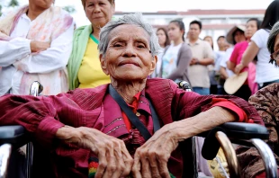 Natividad, 82, waited in her wheelchair outside of Manila's Cathedral overnight to see Pope Francis on Jan. 16, 2015.   Lauren Cater/CNA.