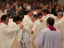 New priests are clothed with chasubles during their ordination Mass in St. Peter's Basilica, April 26, 2015. 