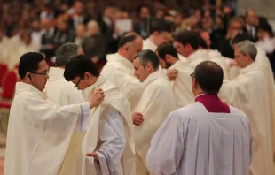 Newly ordained priests are vested during their Mass of Ordination in St. Peter's Basilica, April 26, 2015. Bohumil Petrik/CNA.
