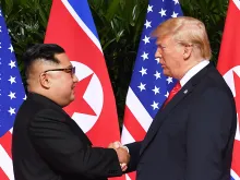 North Korea's leader Kim Jong Un shakes hands with US President Donald Trump at the start of the US-North Korea summit, on Sentosa Island, Singapore, June 12, 2018. 