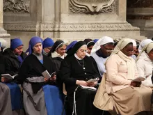 Relgious sisters pray at St. Peter's Basilica. 
