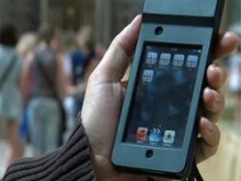 A pilgrim uses an iPod provided by the Vatican's Opera Romana Pellegrinaggi.