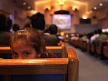 Opponents of Arizona's new immigration enforcement law attend a prayer serivce on April 25, 2010 in Phoenix, Arizona. 
