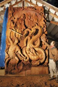 Skip Armstrong stands by a 16-foot-tall door he carved / Photo ?w=200&h=150