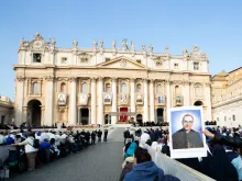 Pilgrims in St. Peter’s Square hold up an image of Saint Oscar Romero at his canonization Mass Oct. 14. 