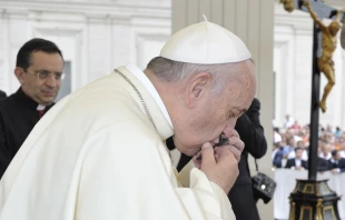 Pope Francis venerates the cross which was buried with Bl. Junipero Serra, whom he will canonize later this month, at the General Audience held Sept. 2, 2015.   L'Osservatore Romano.
