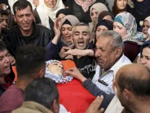 Palestinians mourn the death of Mohammed Hamayel, 15, during his funeral in Beita in the West Bank, March 11, 2020, after he was shot by Israeli forces. 