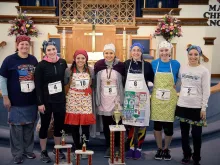 Competitors in the 2018 International Pancake Race from Liberal, Kansas, pose afterwards. Courtesy photo.