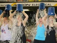 Participants tip buckets of ice water over their heads for the Ice Bucket Challenge in Melbourne, Australia, Aug. 22, 2014. 