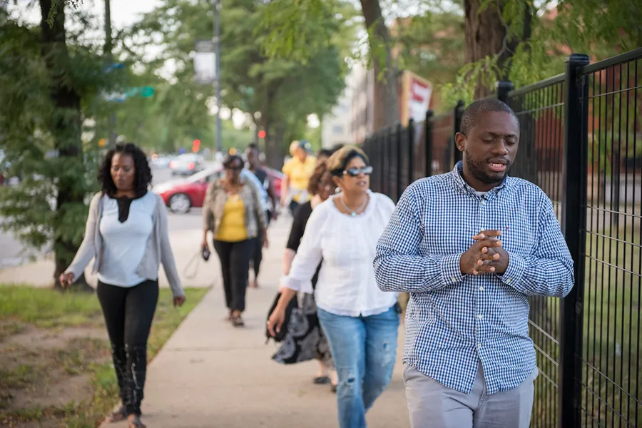 Chris Butler, a pastor at Chicago Embassy Church, leads a prayer walk in his community. ?w=200&h=150