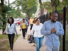 Chris Butler, a pastor at Chicago Embassy Church, leads a prayer walk in his community. 