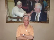 Pat Troy poses in his pub, Irelands Own, on Nov. 29  in front of a picture of himself and his wife meeting Pope Benedict.