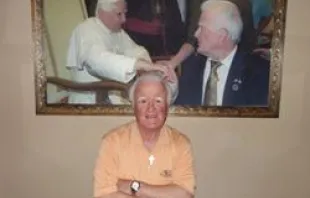 Pat Troy poses in his pub, Irelands Own, on Nov. 29  in front of a picture of himself and his wife meeting Pope Benedict. 