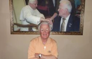 Pat Troy poses in his pub, Irelands Own, on Nov. 29  in front of a picture of himself and his wife meeting Pope Benedict.