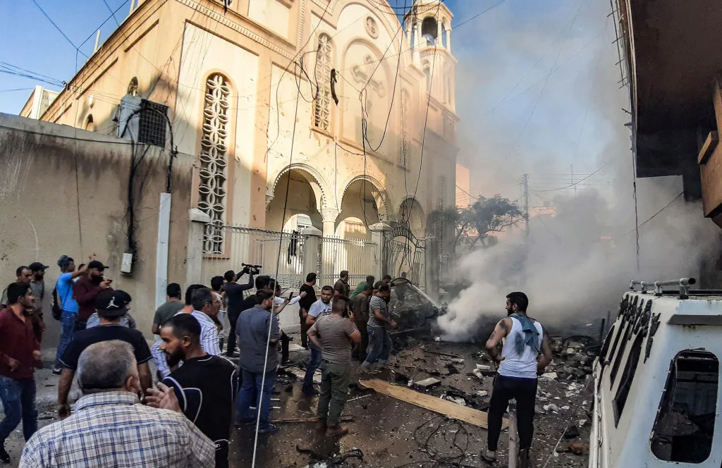 People extinguish a fire at the scene of a car bomb explosion outside the Syriac Orthodox Church of the Virgin Mary in Qamishli, Syria, July 11, 2019. ?w=200&h=150