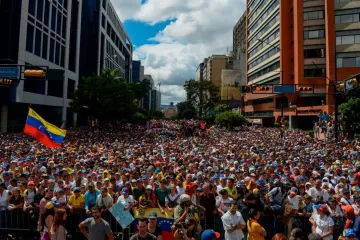 People listen to Venezuelas National Assembly head Juan Guaido out of frame during an opposition rally against Nicolas Maduro in Caracas Jan 23 2019 Credit Federico Parra AFP Getty Images C