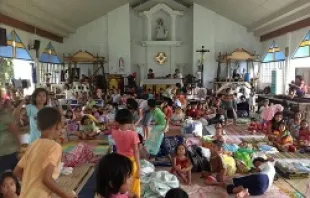 People take shelter in a parish church in the Philippines after Typhoon Haiyan swept through the area.   Caritas Manila.