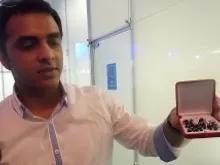 Thomson Philip shows the rosary Pope Francis gave him (