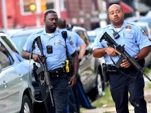 Police officers carrying assault rifles respond to a shooting on August 14, 2019 in Philadelphia, Pennsylvania.  