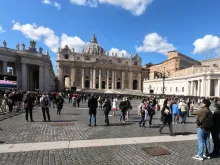 Pilgrims in St. Peter's Square watch video broadcast of the Angelus March 8, 2020. 