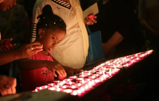 Pilgrims pray before a statue of Our Lady of Fatima in Lisbon, May 9, 2017.   Daniel Ibanez/CNA.