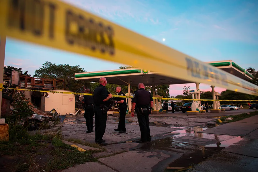 Police officers stand guard as crowds gather for a second night near a BP gas station that was burned after an officer-involved killing Aug. 14, 2016 in Milwaukee. ?w=200&h=150