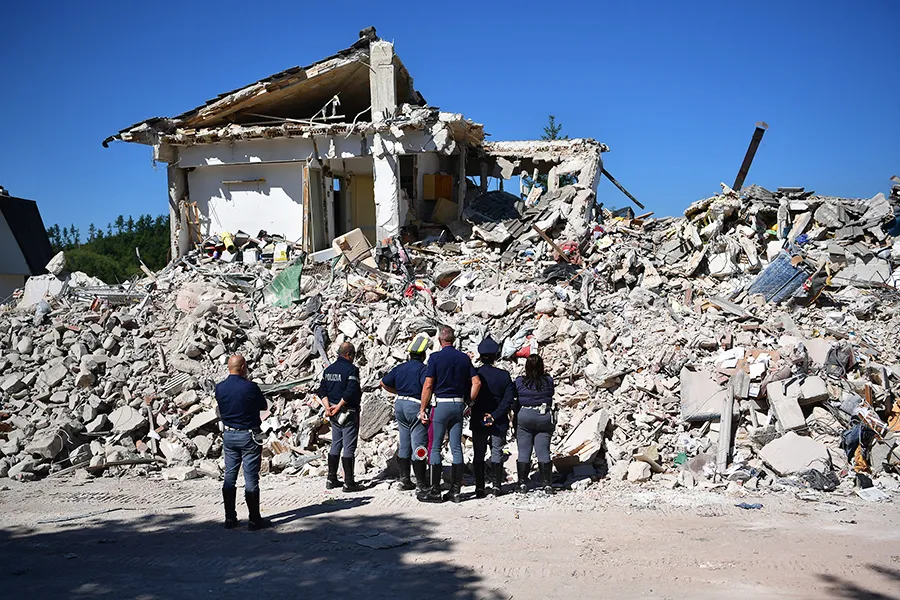 Police officers view the remains of a building that was destroyed during an earthquake, on August 25, 2016 in Amatrice, Italy. ?w=200&h=150