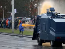 Police use a water cannon truck to disperse demonstrators during a rally to protest against the Belarus presidential election results in Minsk, Oct. 11, 2020. 