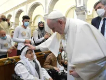 Pope Francis blesses a young boy in the Syriac Catholic Church of the Immaculate Conception in Bakhdida, Iraq, on March 7, 2021. Photo credits: Vatican Media.