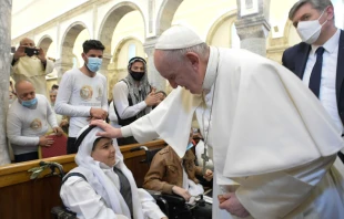 Pope Francis blesses a young boy in the Syriac Catholic Church of the Immaculate Conception in Bakhdida, Iraq, on March 7, 2021. Photo credits: Vatican Media.