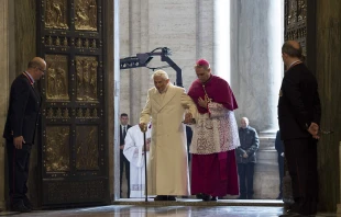 Pope Emeritus Benedict XVI passes through the Holy Door of St. Peter's Basilica for the Jubilee Year of Mercy, Dec. 8, 2015.   L'Osservatore Romano.