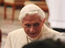 Pope Benedict XVI greets participants at the Feb. 22 Consistory in St. Peter's Basilica, Feb. 22, 2014. 