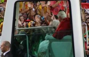 Pope Benedict XVI is greeted by pilgrims.  