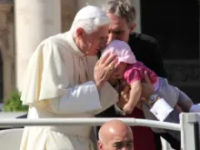 Pope Benedict kisses a baby girl during the Oct. 10, 2012 general audience in St. Peter's Square. 